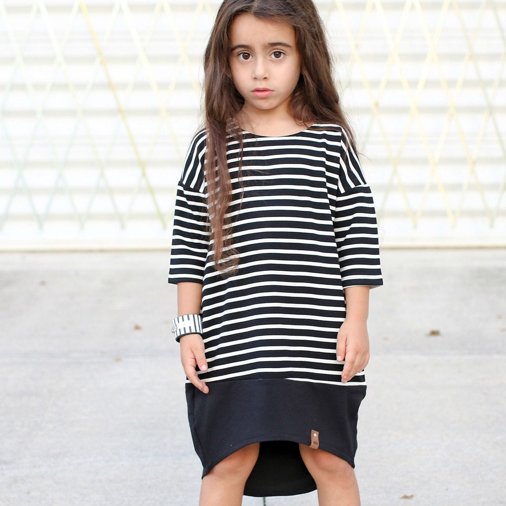 Trendy dressed girl in black and white striped dress by Mini Street