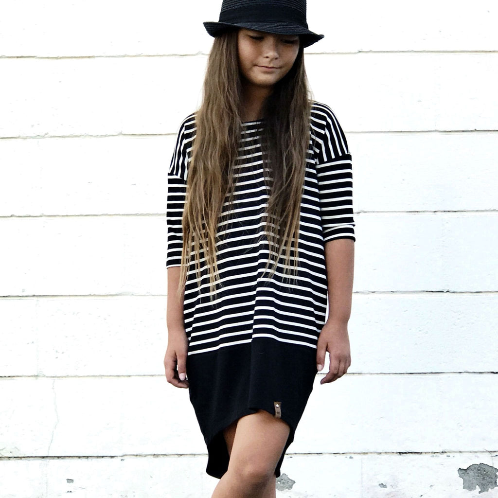 Stylish girl in monochrome striped dress by Mini Street